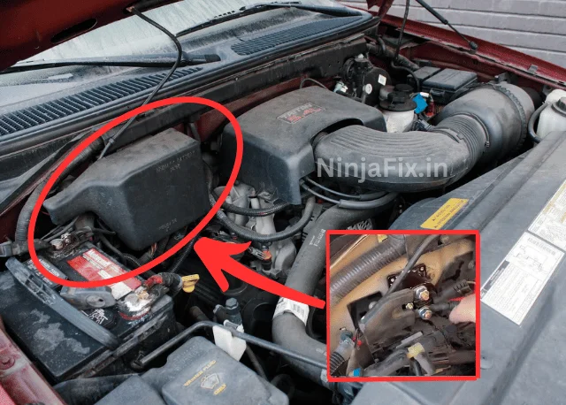 pic of 1997 ford f 150 engine bay with red arrow marking to showcase the location of starter relay which is mounted on front fender  